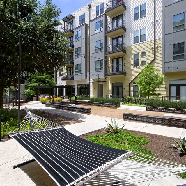 The Arnold - Outdoor Seating with Fire Pit and Apartment Building View
