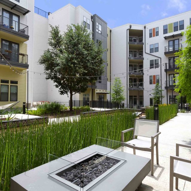 The Arnold - Outdoor Seating with Fire Pit and Apartment Building View