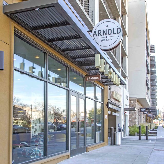 The Arnold - Leasing Office Exterior View with Apartment Logo