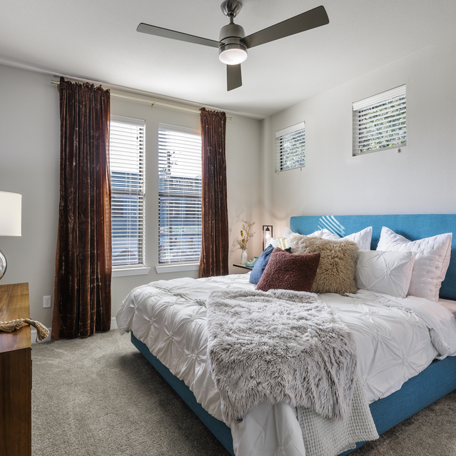 The Arnold - Bedroom with Ceiling Fan and Large Curtains