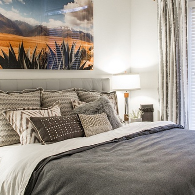 The Arnold - Bedroom with Cozy Lighting and Large Window