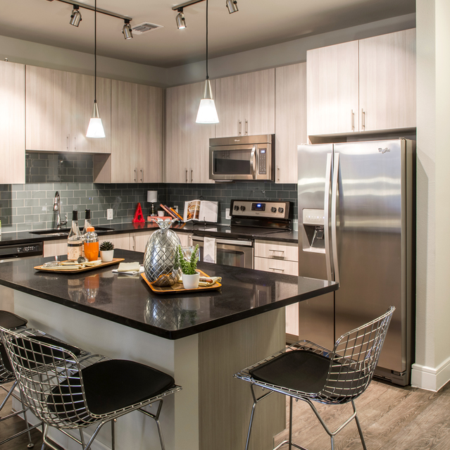 The Arnold - Dining and Kitchen Area with Warm Lighting