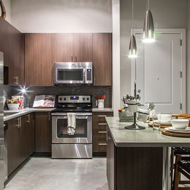 The Arnold - Kitchen with Stainless Steel Appliances and Table Counter