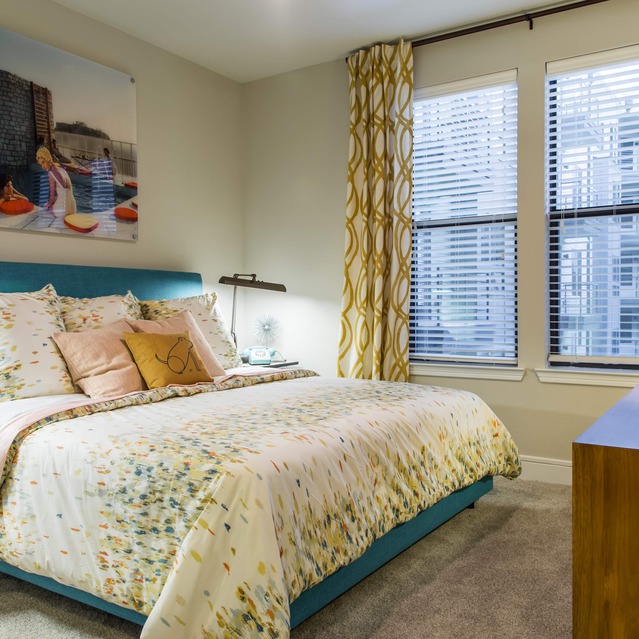 The Arnold - Cozy Bedroom with Large Windows and Warm Lighting